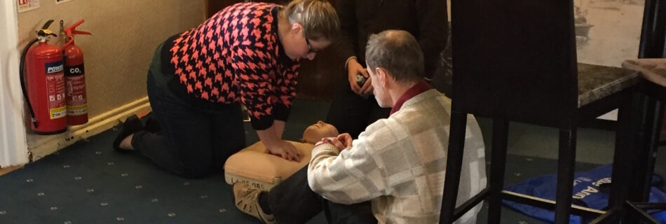 Club members practicing resuscitation on a mannequin